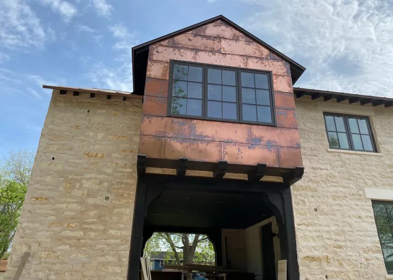 Copper metal panel facade on a stone building for Roof Repair in Sulphur Springs