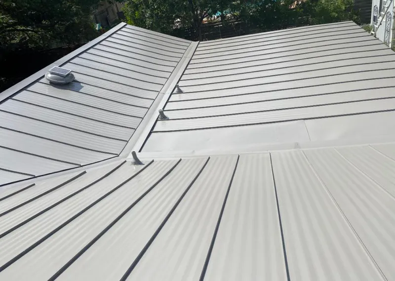 Solar attic fan installed on a metal roof for Roof Ventilation in Sulphur Springs